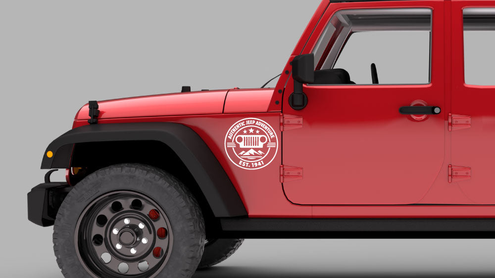 Red Jeep Wrangler JK with white “Authentic Jeep Adventure” badge fender decal on front fender