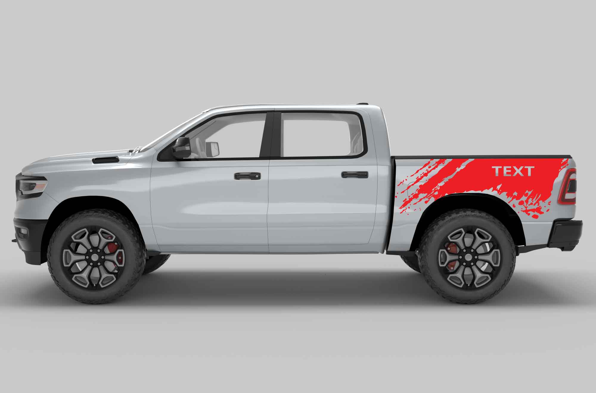 Side view of a silver dodge ram pickup truck with custom text decals on the side bed in red color