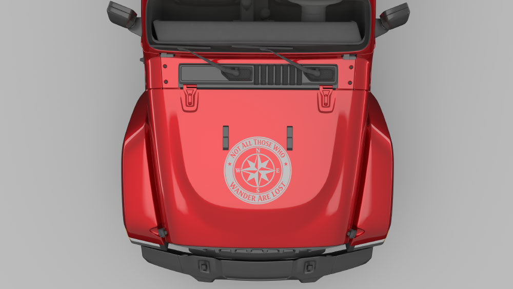 Gray wanderers compass circle hood decal installed on red Jeep Wrangler JL hood, adventure-themed vinyl graphic.