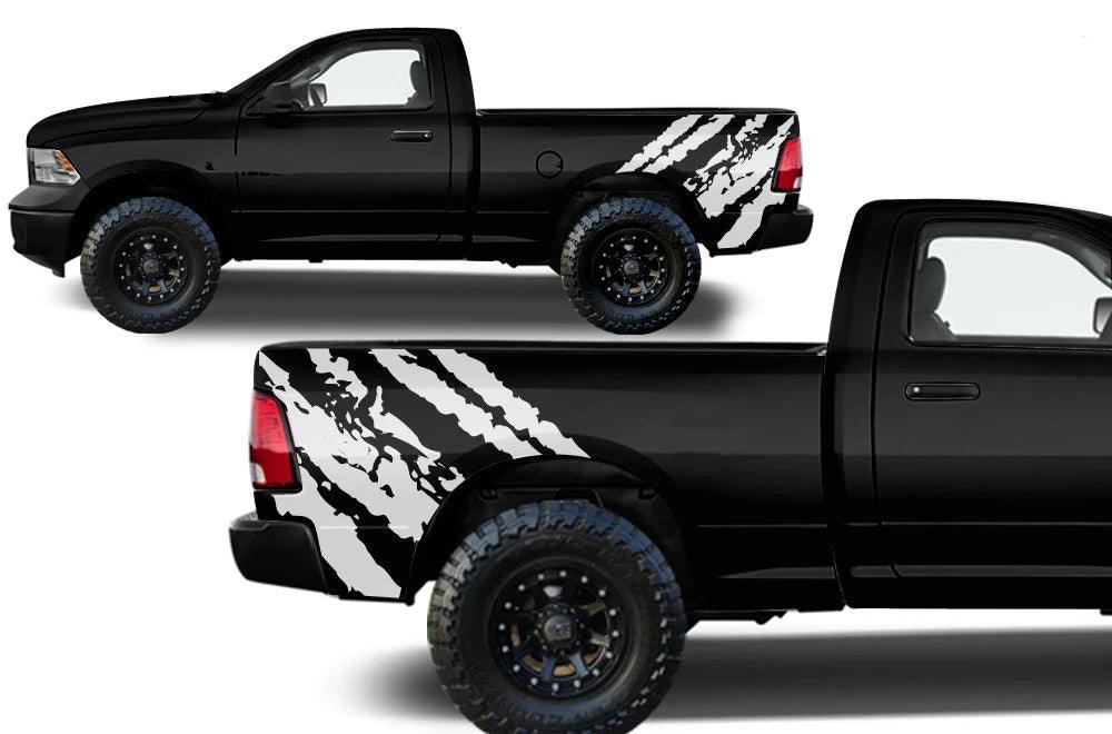 Side angle of a 2009–2018 Dodge Ram 1500 with rugged off-road bed splash decals highlighting asymmetrical vinyl graphics on the rear bed section.