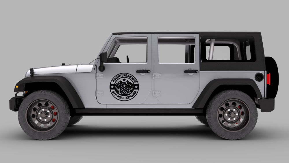 Silver Jeep Wrangler JK side view with black “Adventure Awaits” off-road badge door decal