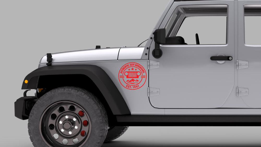 Silver Jeep Wrangler JK with red “Authentic Jeep Adventure” badge fender decal on front fender