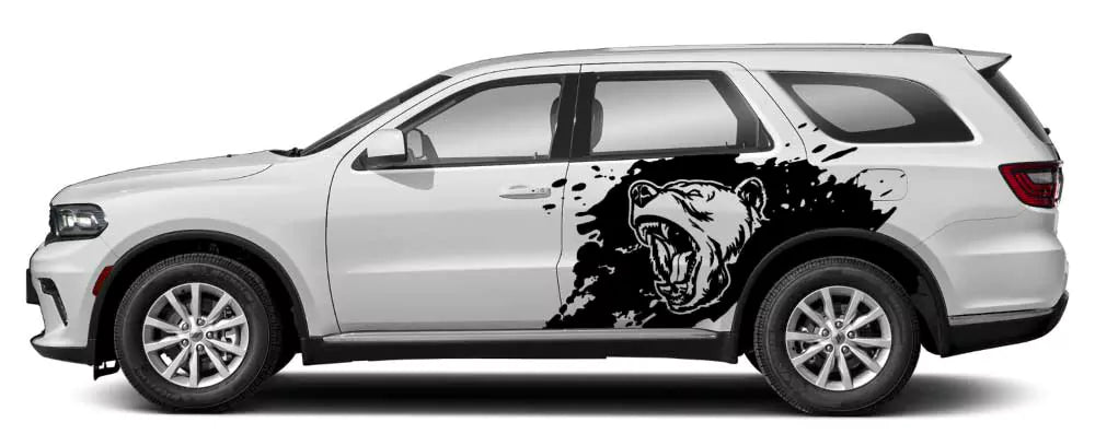 White Dodge Durango with black roaring bear splash side decal graphic on rear door and quarter panel.