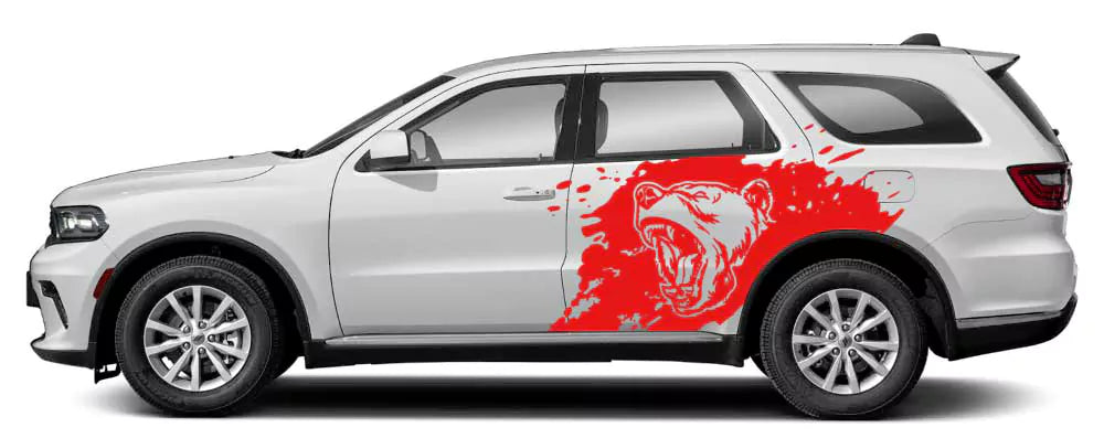 White Dodge Durango with red roaring bear splash side decal graphic on rear door and quarter panel.